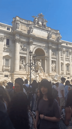 Tourist in white headscarf visits Rome's landmarks