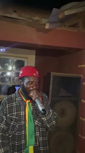 Nighttime community celebration with music and Ghanaian flags in Nigeria