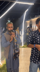 Live folk music at a nighttime outdoor event in Quetta