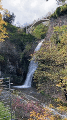 Waterfall and white bridge captured in scenic Tbilisi landscape