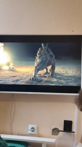 Resident watches creature feature film on television in Tobolsk