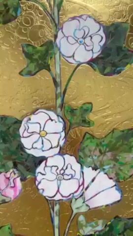 The video presents a close-up view of a painted artwork. The artwork is divided into three panels. The background of the artwork is a textured gold color. Each panel features floral motifs consisting of tall, leafy stems with white, pink, and red flowers. The leaves are depicted in shades of green. The camera zooms out, showcasing the complete artwork displayed on a wall. The artwork seems to be exhibited in a public space, possibly a gallery or museum.