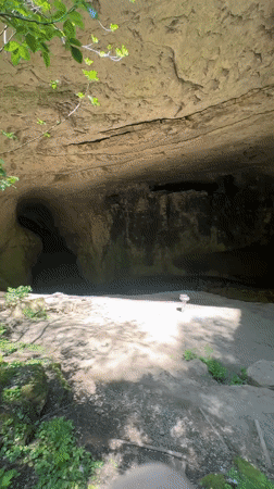 Tourist explores Bulgarian cave system and natural bridge formations