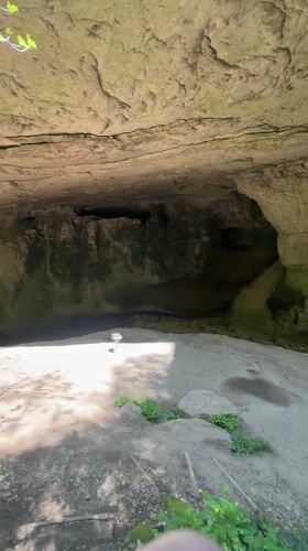 Tourist explores Bulgarian cave system and natural bridge formations