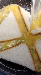 Egg poured over bread slices arranged in a cross pattern