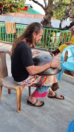 Street musician plays handpan drum in Bhagsu, India