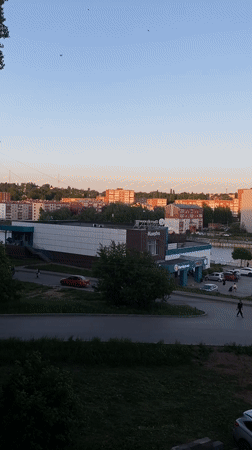 Sunburned woman takes selfies in Votkinsk at dusk
