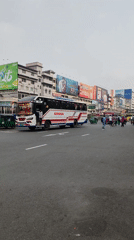 Bus travels through overcast Dhaka street