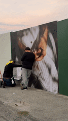 Workers install bread advertisement on fence in Naucalpan