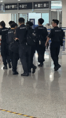 Security team moves through Liangjiang airport terminal