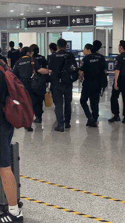 Security team moves through Liangjiang airport terminal