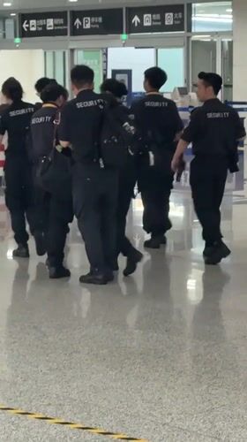 Security team moves through Liangjiang airport terminal