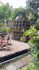Women sunbathe near firepit in tropical Thai outdoor space