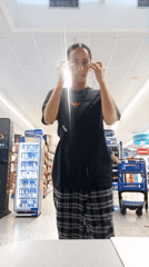Woman photographed smiling at store checkout in Pampatar