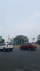 Mixed traffic and street life on a commercial Bekasi road