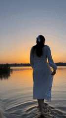 Sunset evening at Ternopil Lake, wading and rowing on still water