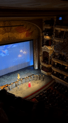 Musical performance with singer, orchestra captured at Khimki theatre
