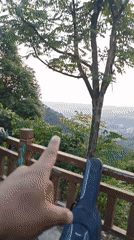 Person points to guitar case near fence in Shapingba District