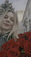 Woman with roses documented during afternoon walk in Sevastopol