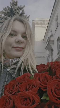 Woman with roses documented during afternoon walk in Sevastopol