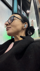 Woman with earbuds rides public transport in Saint Petersburg