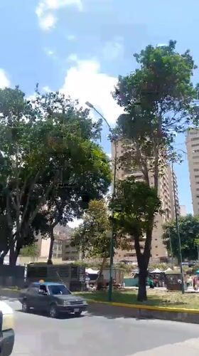 Ambulances, pedestrians observed during afternoon hours in central Caracas