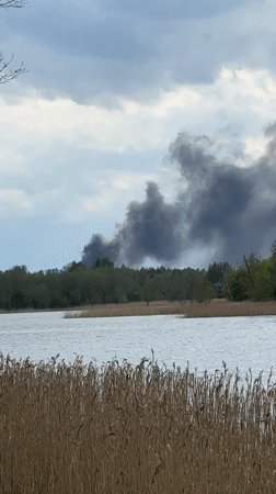 Dark smoke plume spotted rising above trees near Latvian lake