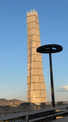Woman takes elevator selfies near reflective monument in Tbilisi