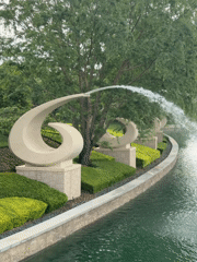 Visitors gather at Universal Studios Beijing entrance, fountains captured