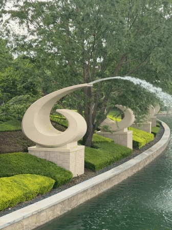 Visitors gather at Universal Studios Beijing entrance, fountains captured