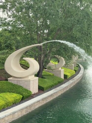 Visitors gather at Universal Studios Beijing entrance, fountains captured