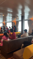 Ship tour group gathers in brightly lit lounge area