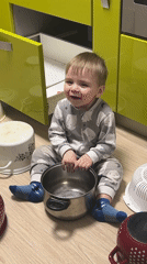 Toddler plays in Perm kitchen during afternoon family time