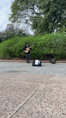 Street musician performs as commuters use Buenos Aires subway