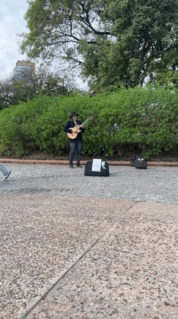 Street musician performs as commuters use Buenos Aires subway
