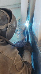Welder performs arc welding in confined space, Russia