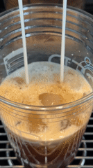 Milk dispensed into iced coffee drink in Vancouver
