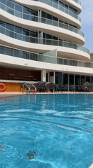 Lap swimming in a clear outdoor pool, Lusail, Qatar