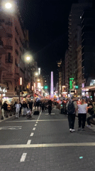 Street musician performs as Buenos Aires nightlife continues