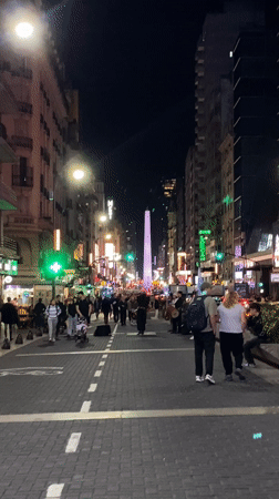 Street musician performs as Buenos Aires nightlife continues