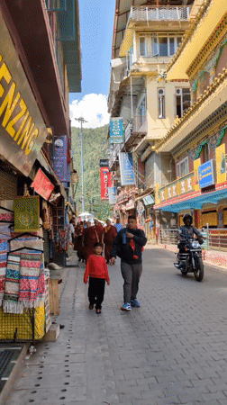 Morning street life observed in Dharamshala near decorated temple