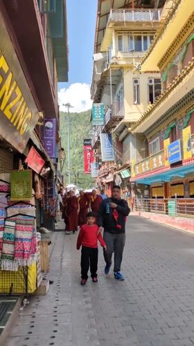 Morning street life observed in Dharamshala near decorated temple
