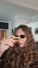 Woman photographed using vintage yellow Kodak camera in Cape Town