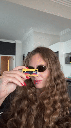 Woman photographed using vintage yellow Kodak camera in Cape Town