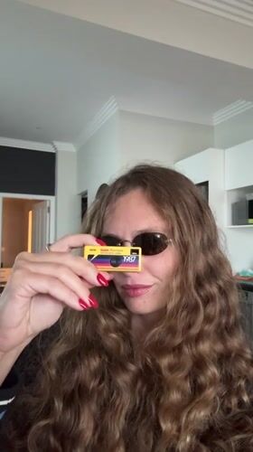 Woman photographed using vintage yellow Kodak camera in Cape Town