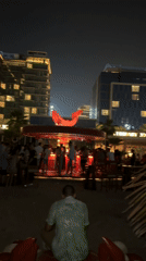 Nighttime crowd fills circular FEBRUARY 30 bar in Dubai