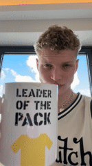 Young man poses with branded mug in London apartment