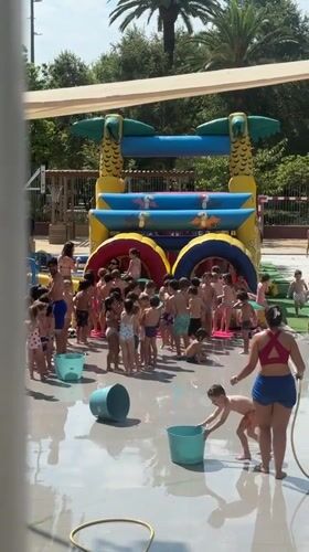 Kids splash around a inflatable obstacle course in Barcelona