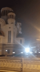 Evening moments captured in Yekaterinburg: illuminated church, relaxing dog
