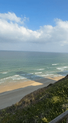 Surfers and paddleboarders out on the Netanya coast